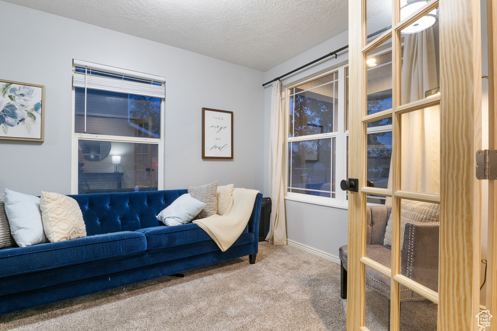 Interior space with french doors and a textured ceiling