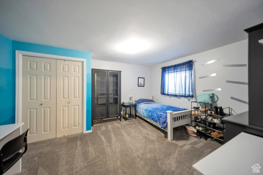 Bedroom with carpet floors and a textured ceiling