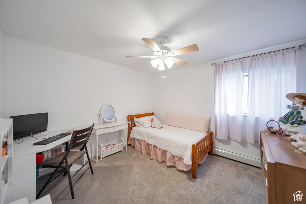 Bedroom featuring ceiling fan, light colored carpet, and a baseboard radiator
