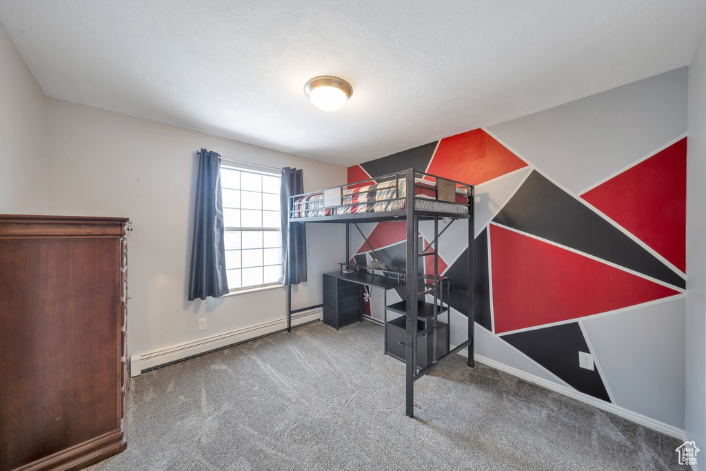 Bedroom featuring carpet flooring and a baseboard radiator