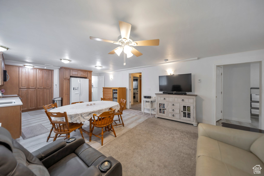 Carpeted living room featuring ceiling fan