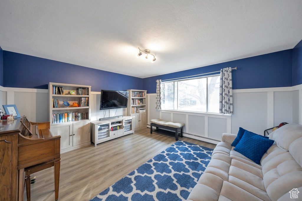 Living room with hardwood / wood-style floors and a textured ceiling