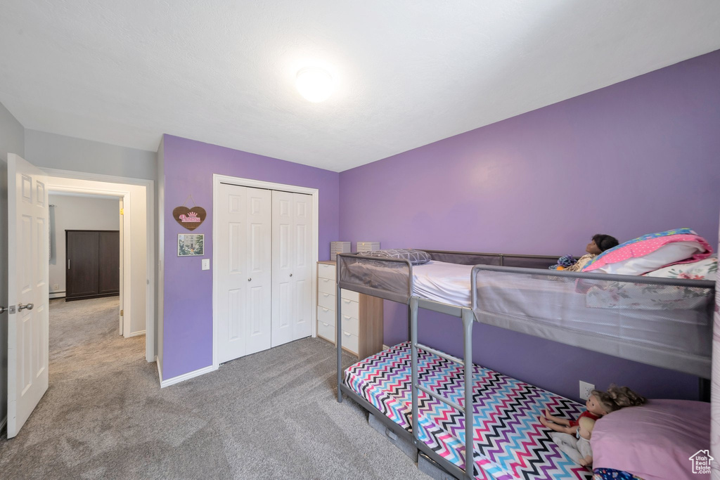 Bedroom featuring carpet flooring and a closet