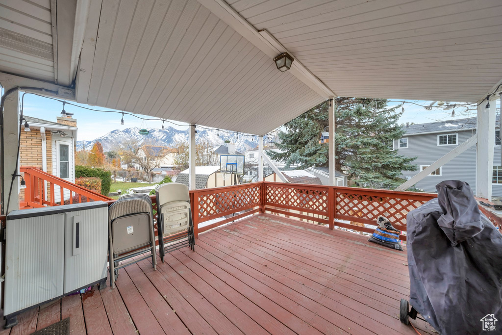 Wooden deck with a mountain view and grilling area