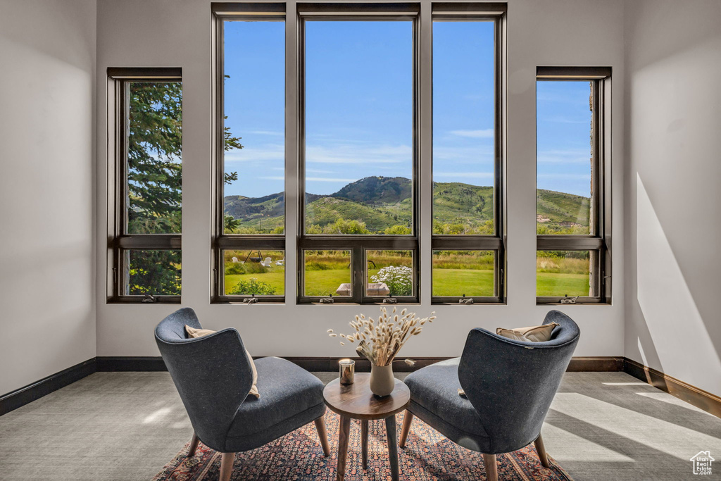 Living area with a mountain view and carpet floors
