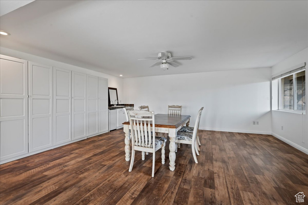 Dining room with ceiling fan and dark hardwood / wood-style floors