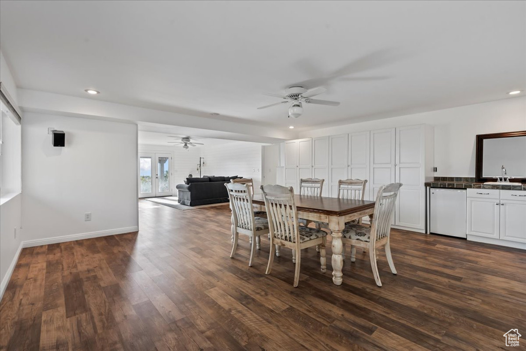 Dining area featuring ceiling fan, dark hardwood / wood-style flooring, and sink