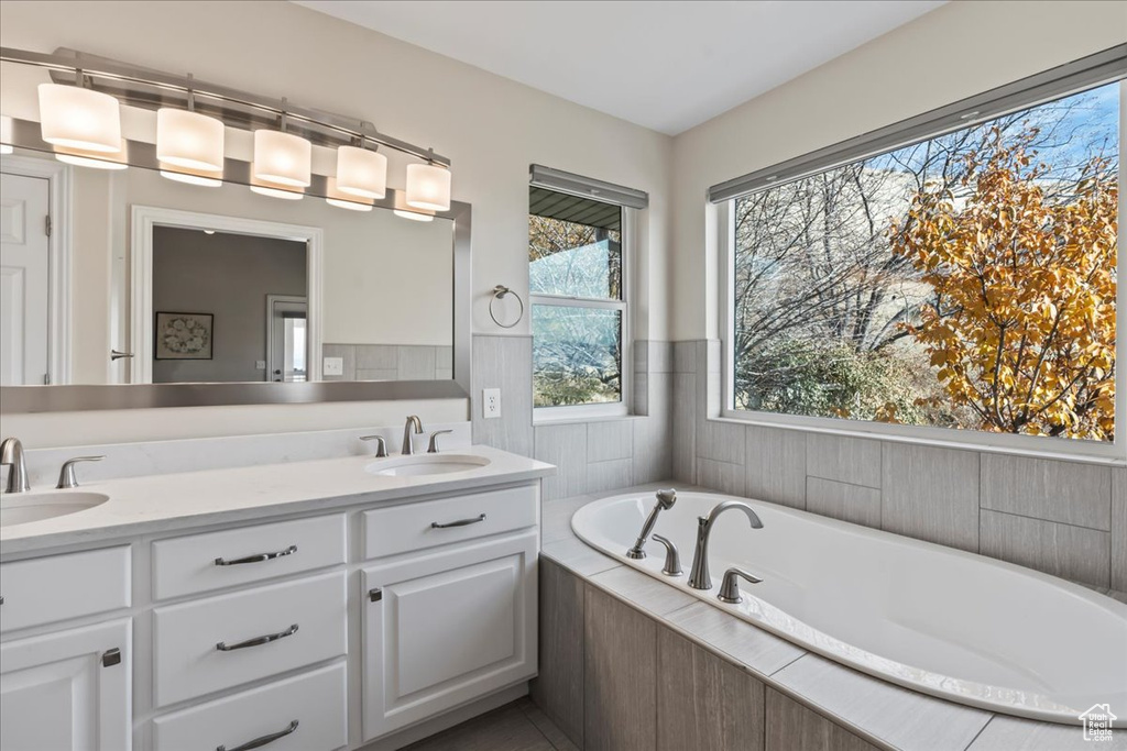 Bathroom featuring vanity and tiled tub