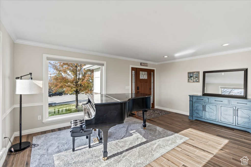 Sitting room featuring crown molding and hardwood / wood-style floors