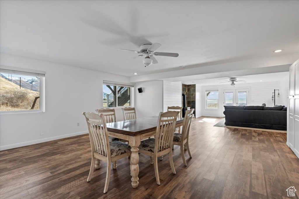 Dining room featuring dark hardwood / wood-style floors, ceiling fan, and french doors