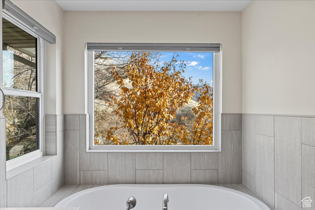 Bathroom with a bathing tub and a wealth of natural light