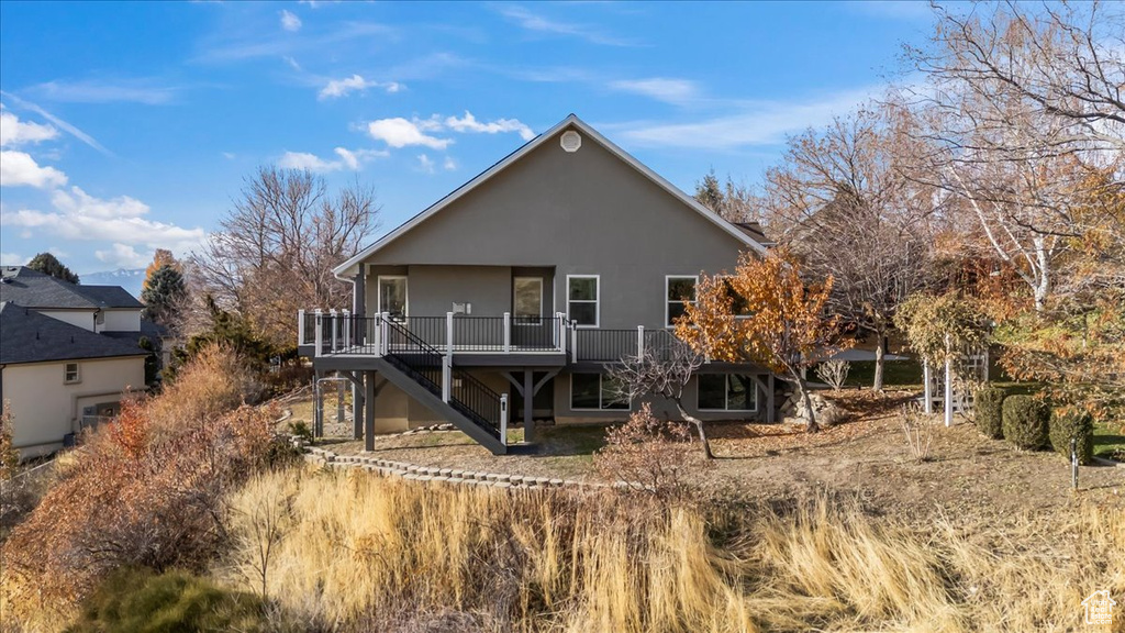 Back of property with a deck