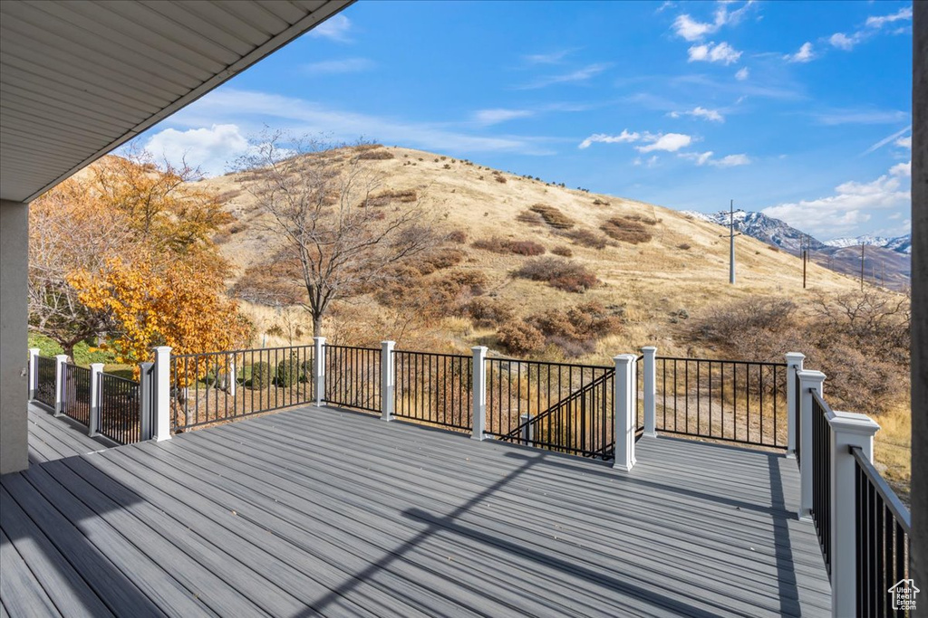 Wooden terrace featuring a mountain view