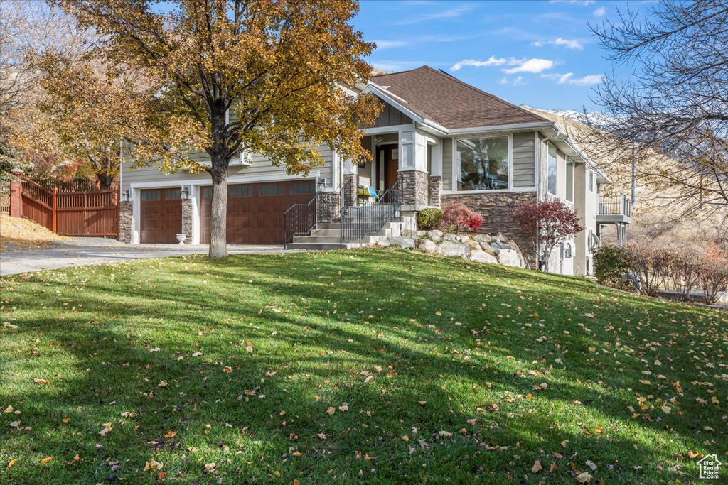 View of front of home featuring a garage and a front yard