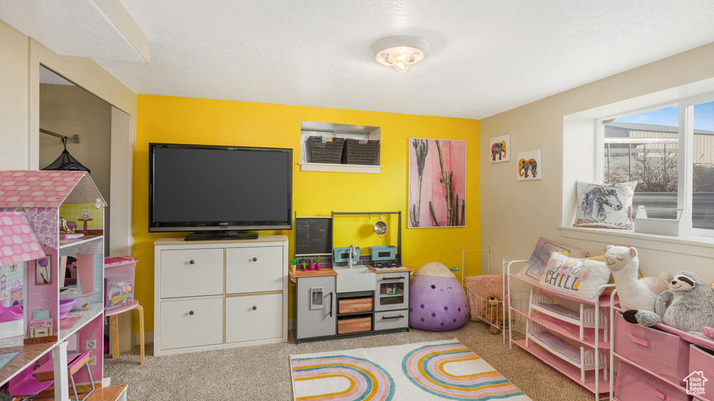 Recreation room featuring light colored carpet