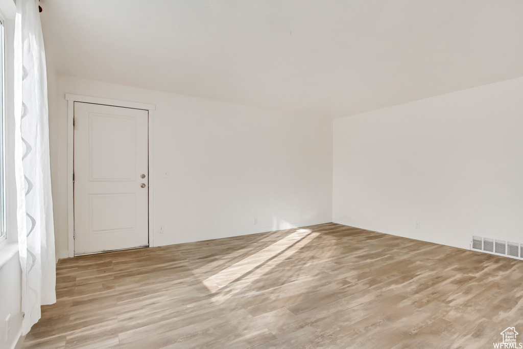 Empty room featuring light hardwood / wood-style flooring