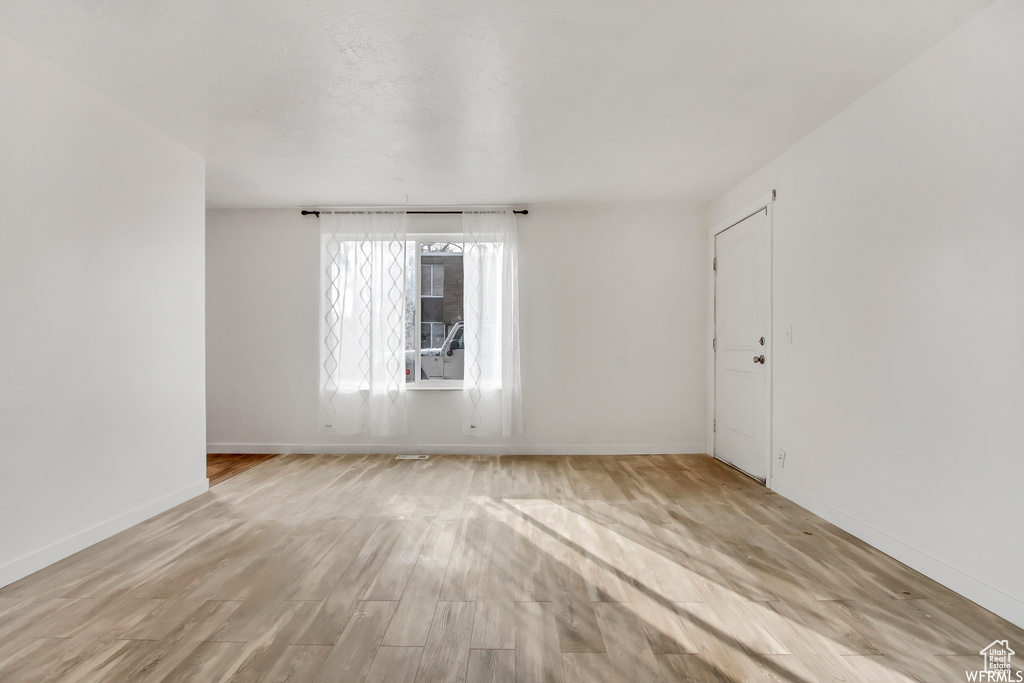 Empty room featuring light wood-type flooring