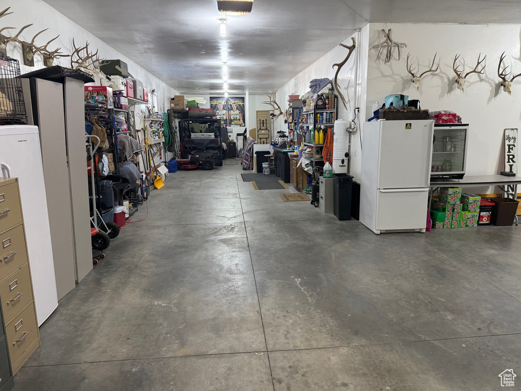 Garage featuring white refrigerator