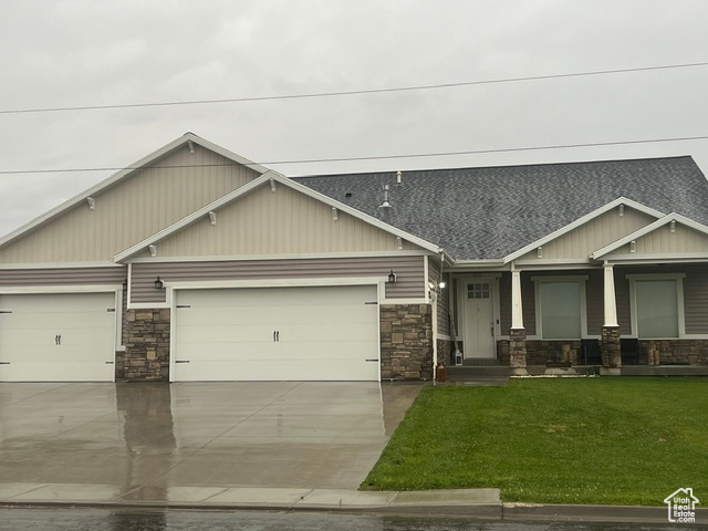 Craftsman-style home with a garage and a front yard