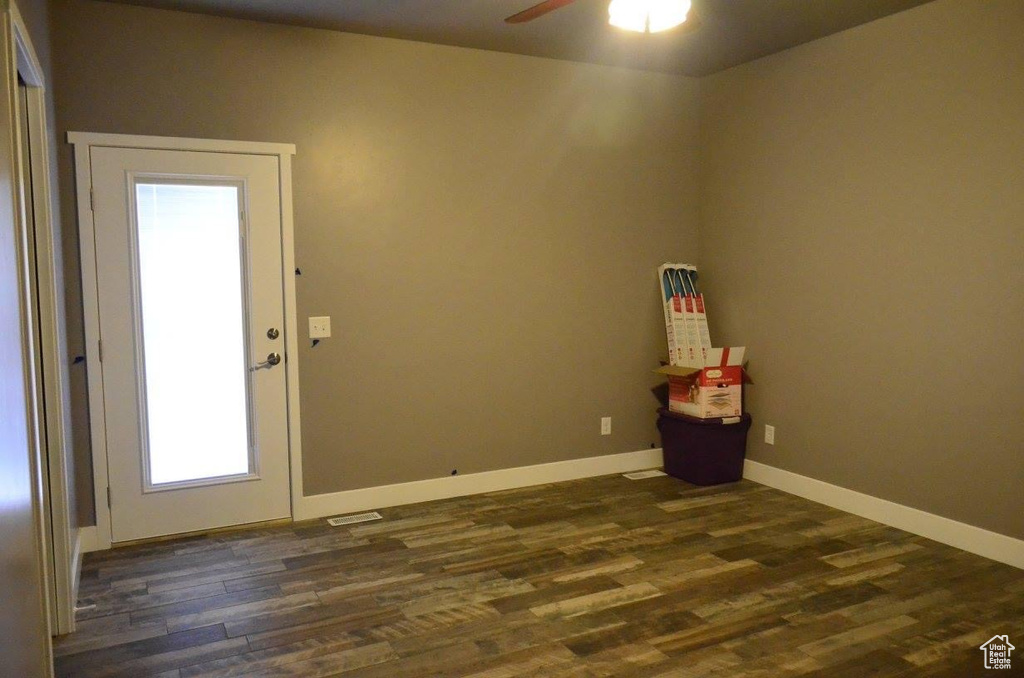 Spare room featuring ceiling fan and dark hardwood / wood-style floors