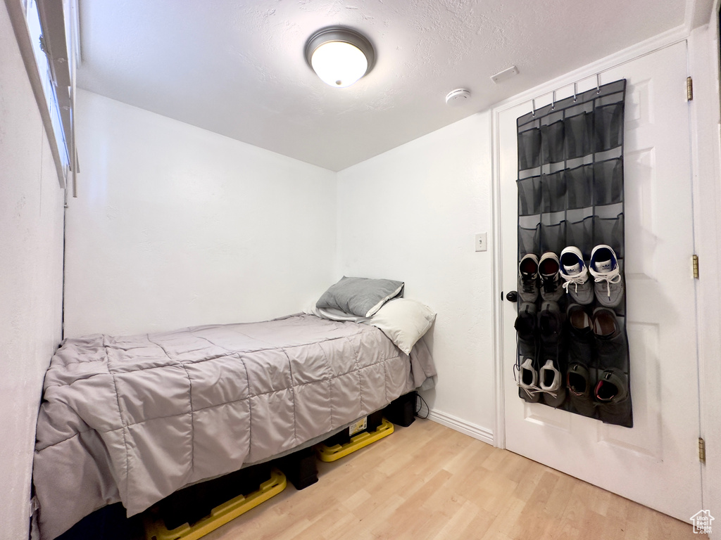 Bedroom featuring wood-type flooring and a textured ceiling