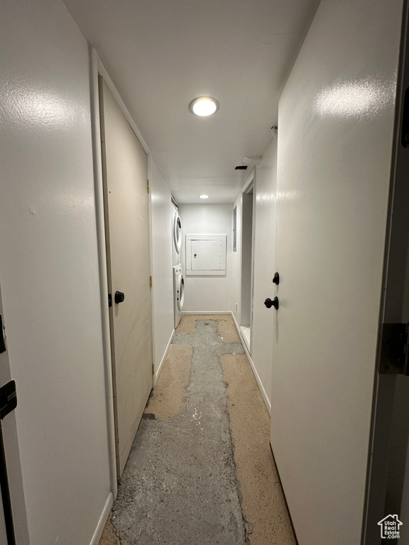 Hallway featuring stacked washing maching and dryer