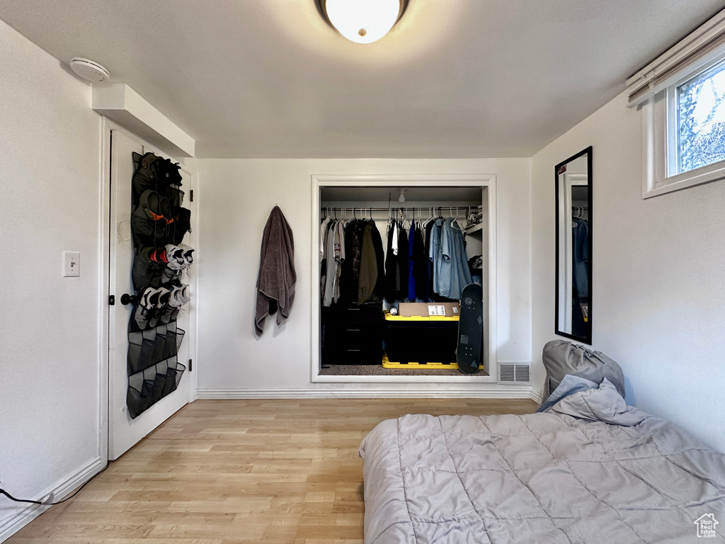 Bedroom featuring a closet and light hardwood / wood-style flooring
