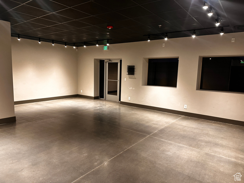 Spare room with concrete flooring and rail lighting