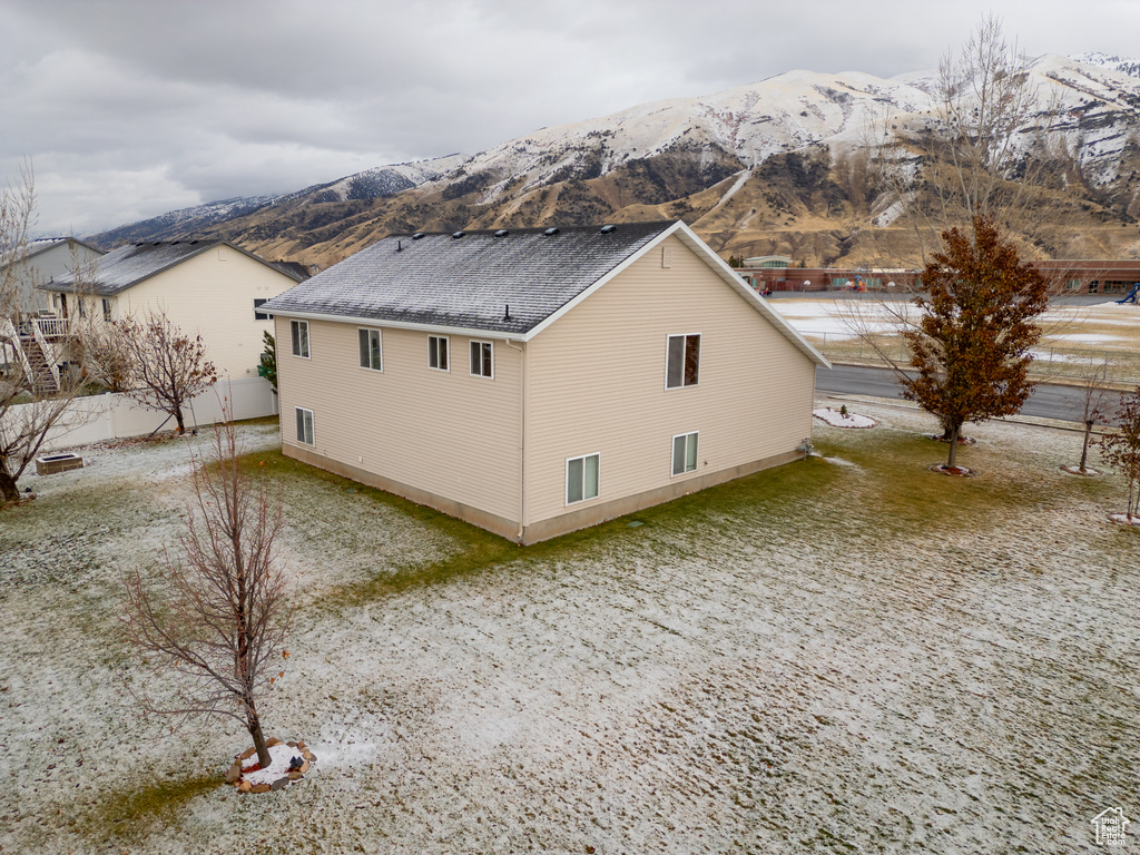 View of side of home with a mountain view