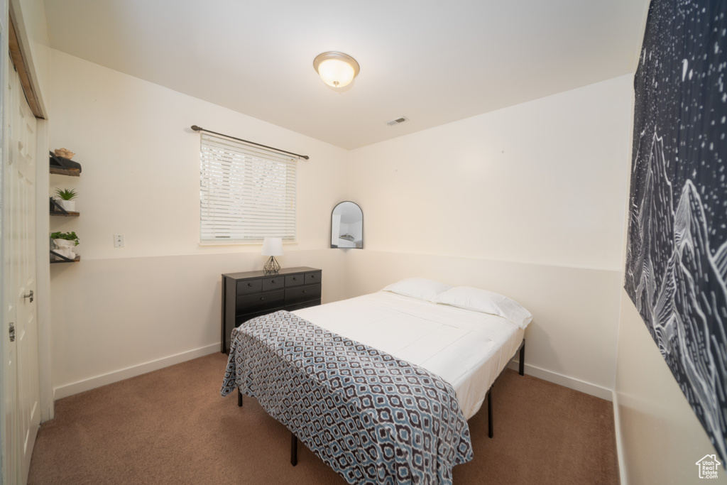 Carpeted bedroom with lofted ceiling