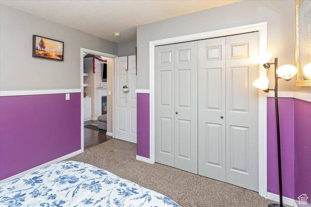 Carpeted bedroom featuring a closet