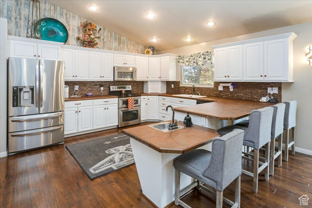 Kitchen with white cabinets and appliances with stainless steel finishes