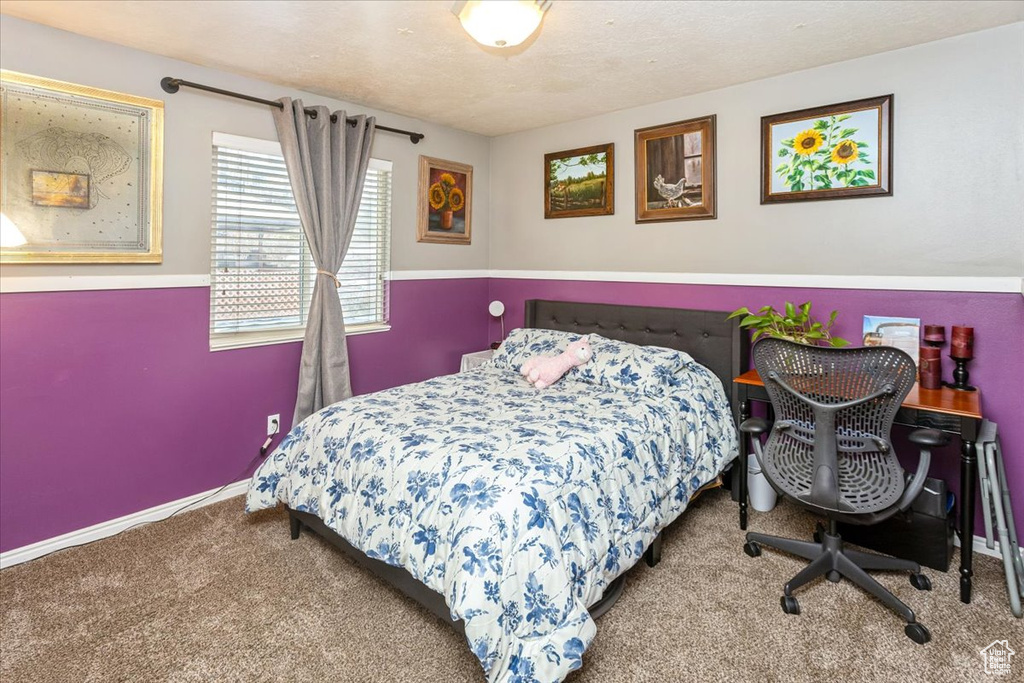 Carpeted bedroom with a textured ceiling