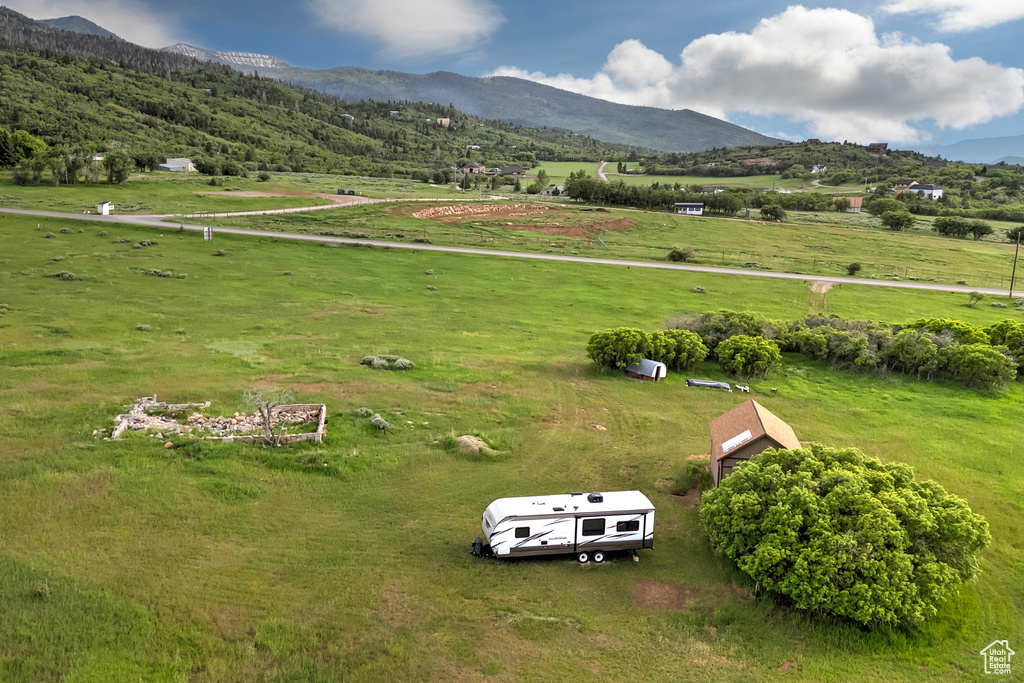 View of rural area featuring a mountainous background and agricultural land