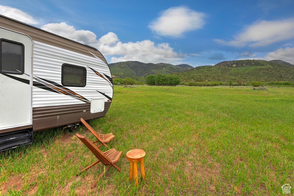 View of grassy yard with a mountain view