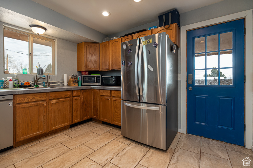 Kitchen with sink and stainless steel appliances