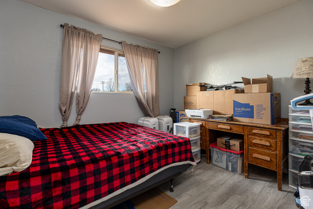 Bedroom with light hardwood / wood-style flooring