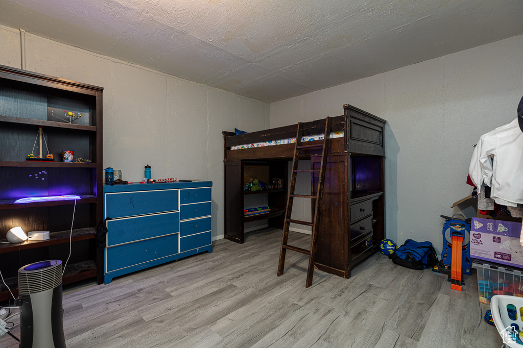 Bedroom with hardwood / wood-style floors