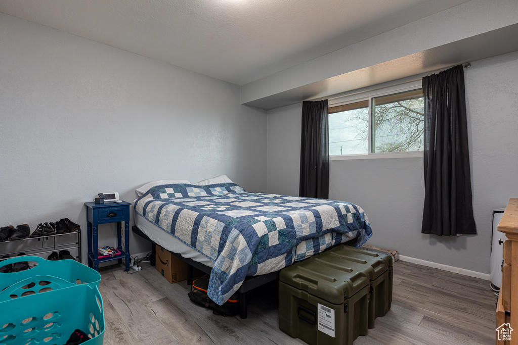Bedroom with hardwood / wood-style flooring