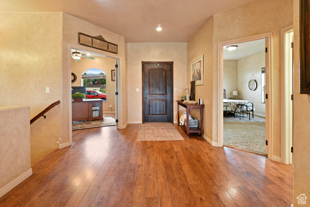 Entrance foyer featuring hardwood / wood-style floors and ceiling fan