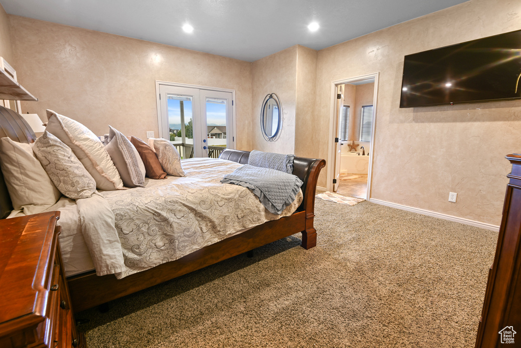 Bedroom featuring carpet flooring, access to exterior, ensuite bathroom, and french doors