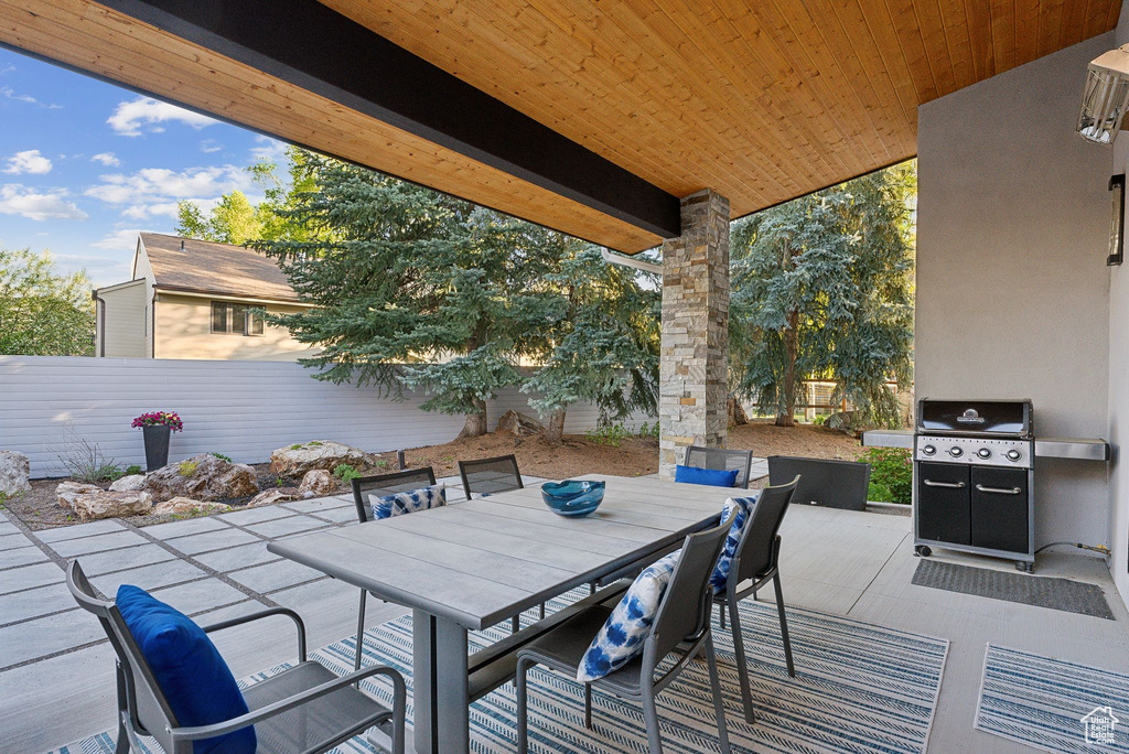 View of patio with grilling area and outdoor dining space