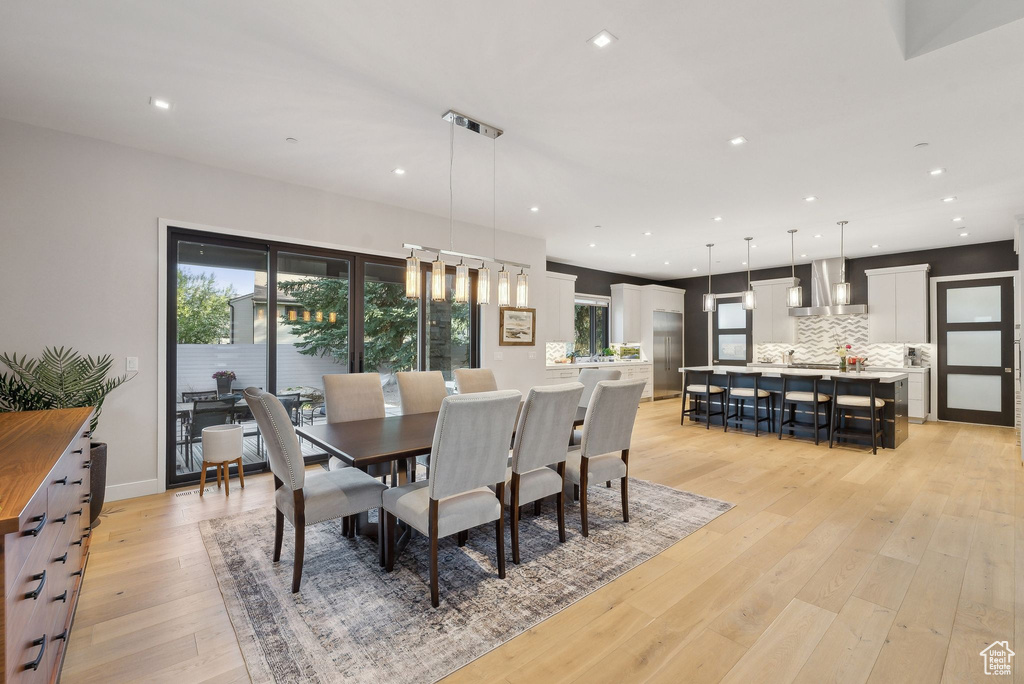 Dining space featuring healthy amount of natural light, light wood-style floors, and recessed lighting