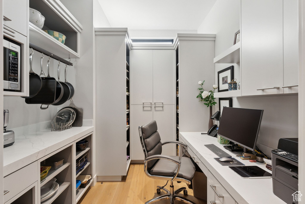 Office with light wood-style floors