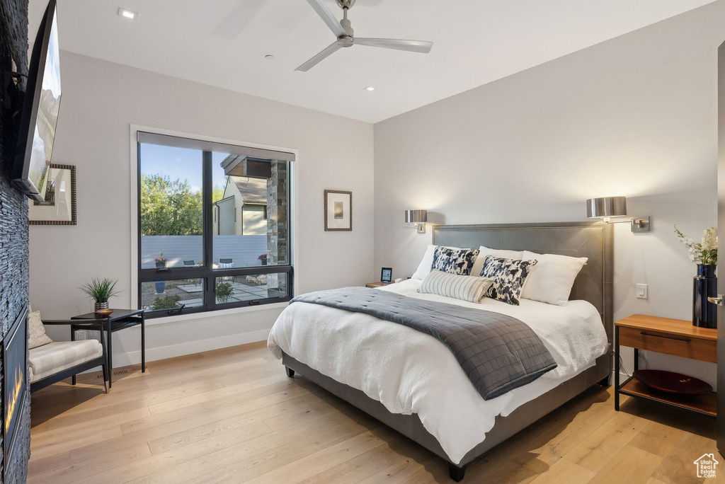 Bedroom with light wood-style flooring, recessed lighting, ceiling fan, and baseboards