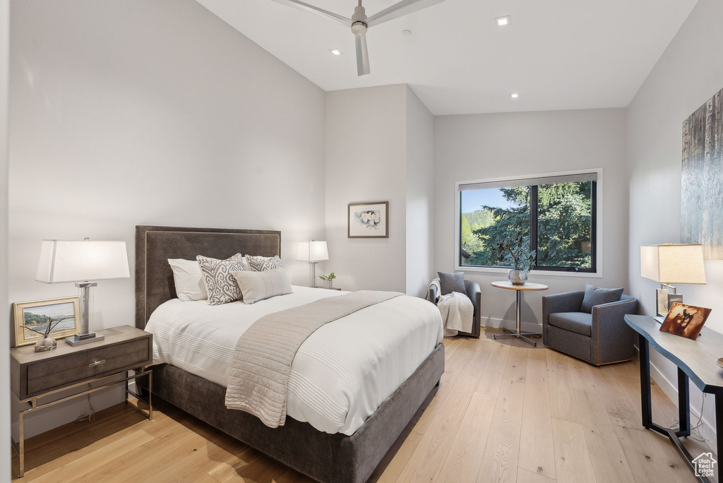 Bedroom featuring light wood-style floors, recessed lighting, and lofted ceiling