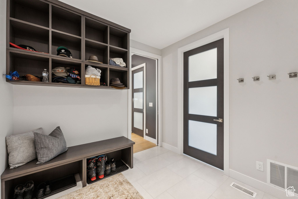 Mudroom featuring baseboards and light tile patterned floors