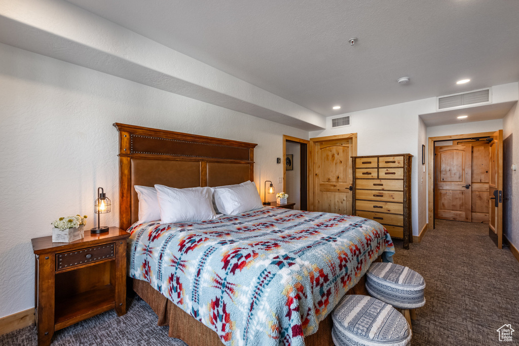 Carpeted bedroom featuring recessed lighting and baseboards