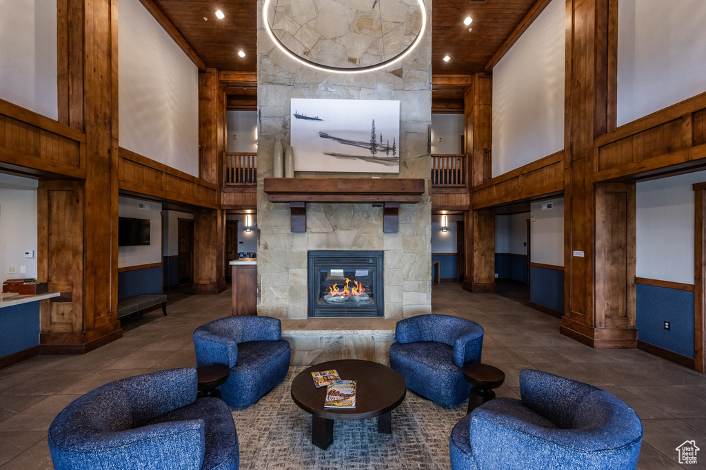 Community lobby with a towering ceiling, wood ceiling, and recessed lighting