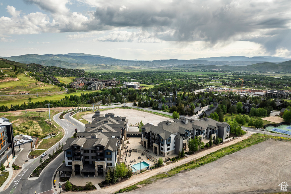 Drone / aerial view of a mountain backdrop and a pool area